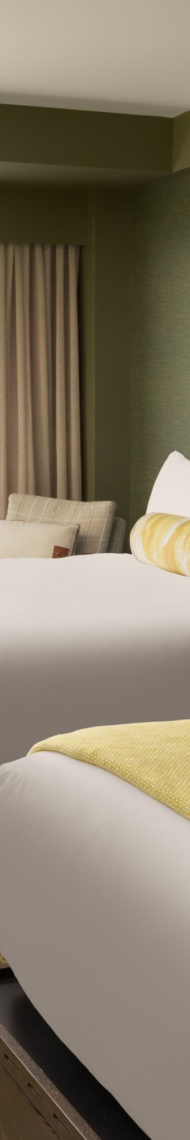 room with two queen beds and sitting area