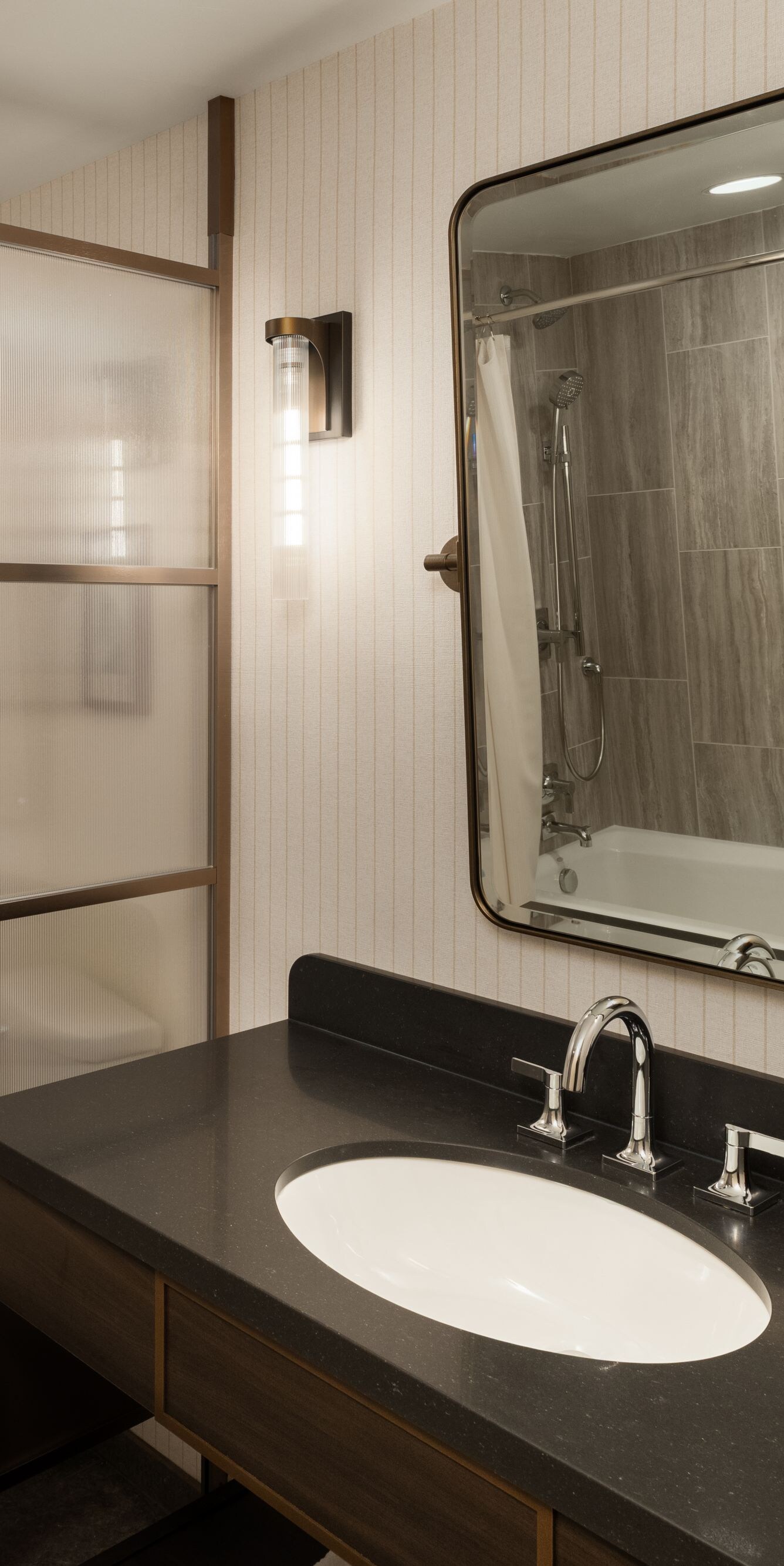 Vanity sink, mirror and reflection of a tub/shower