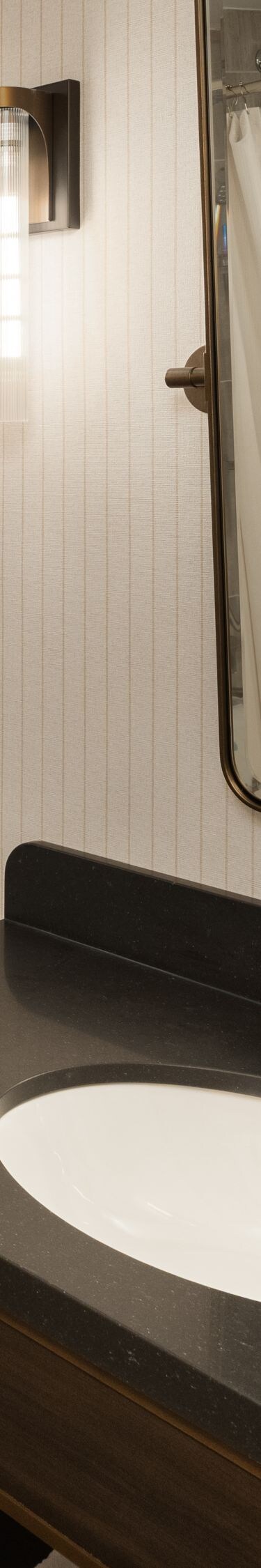 Vanity sink, mirror and reflection of a tub/shower