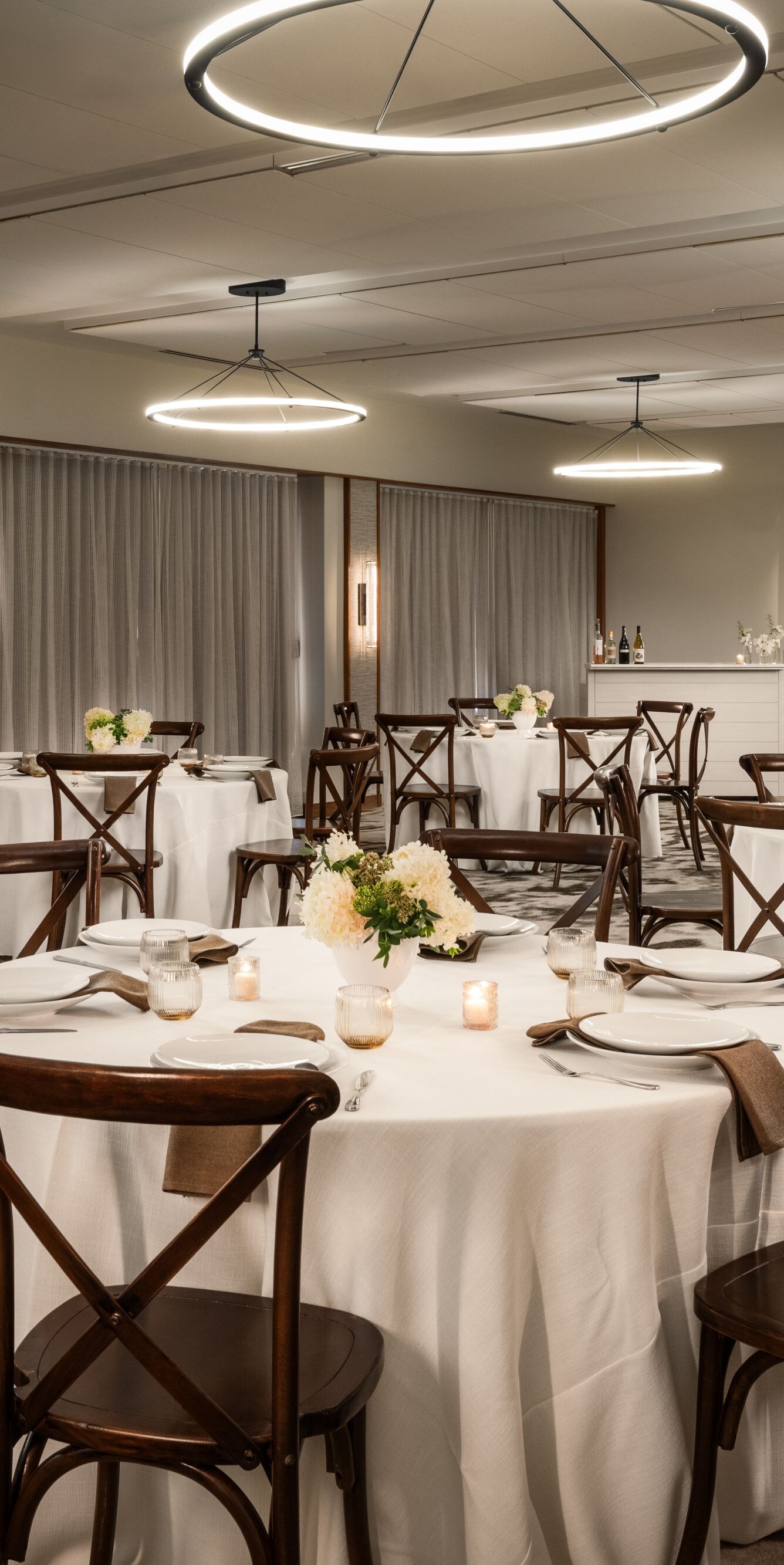 Six large round tables set for dinner event space