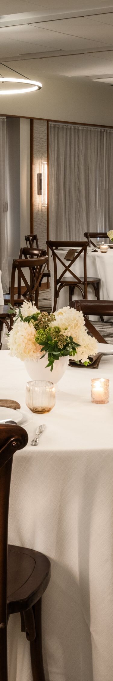 Six large round tables set for dinner event space