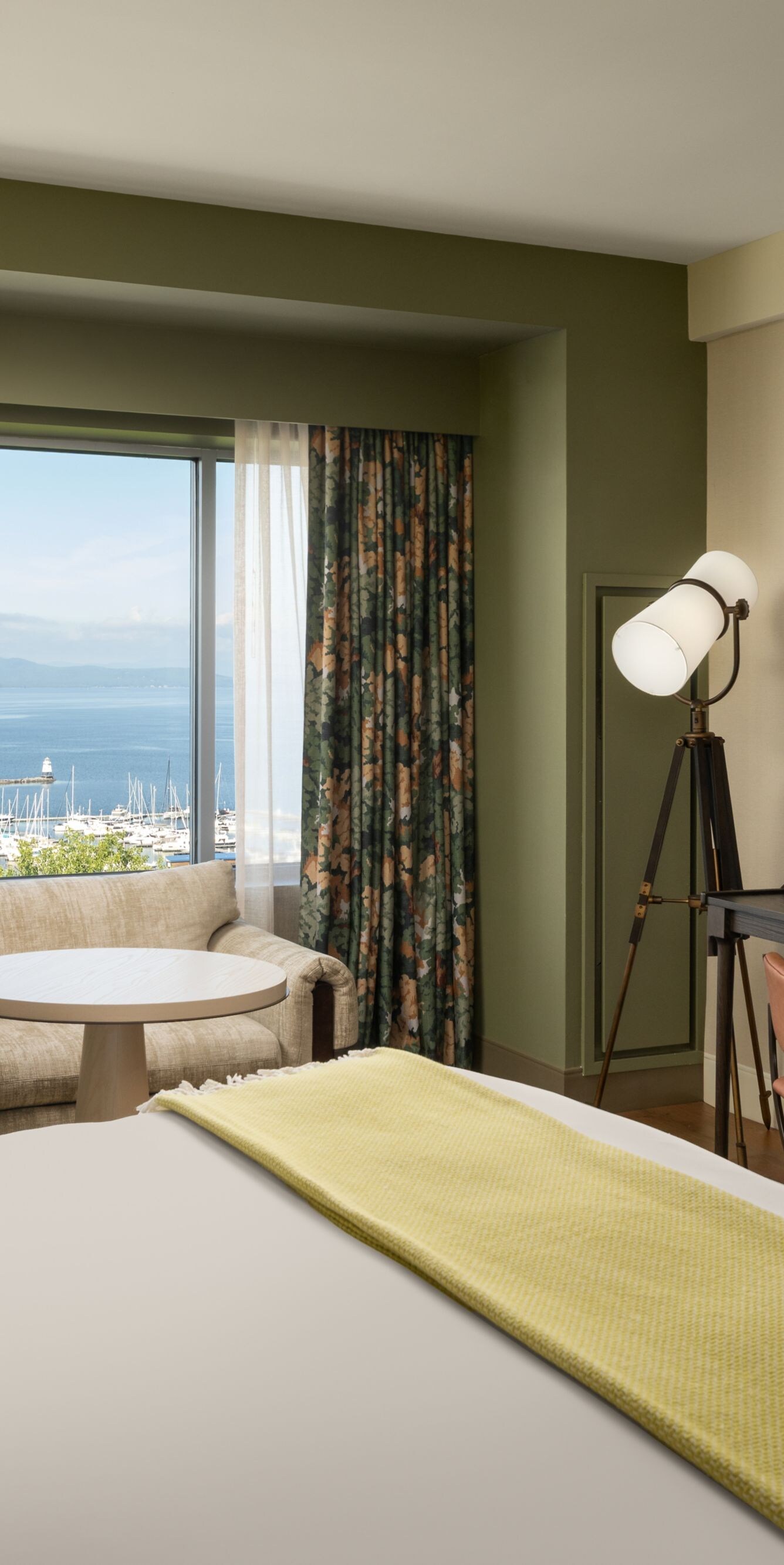 King guest room with couch and lake view