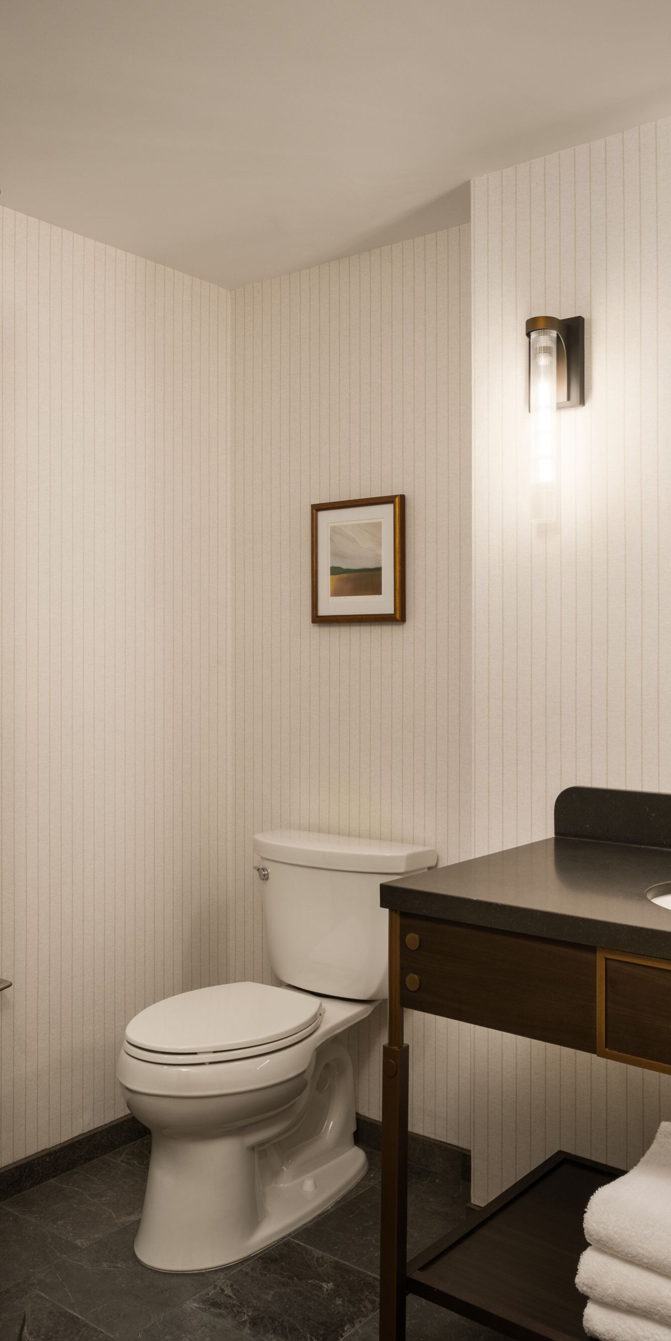 Corner shower, vanity with mirror and toilet