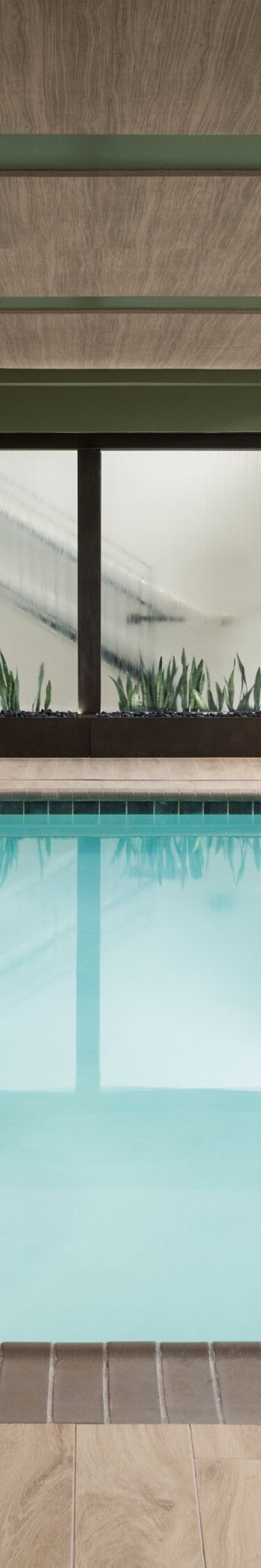 Indoor pool with seating and water feature