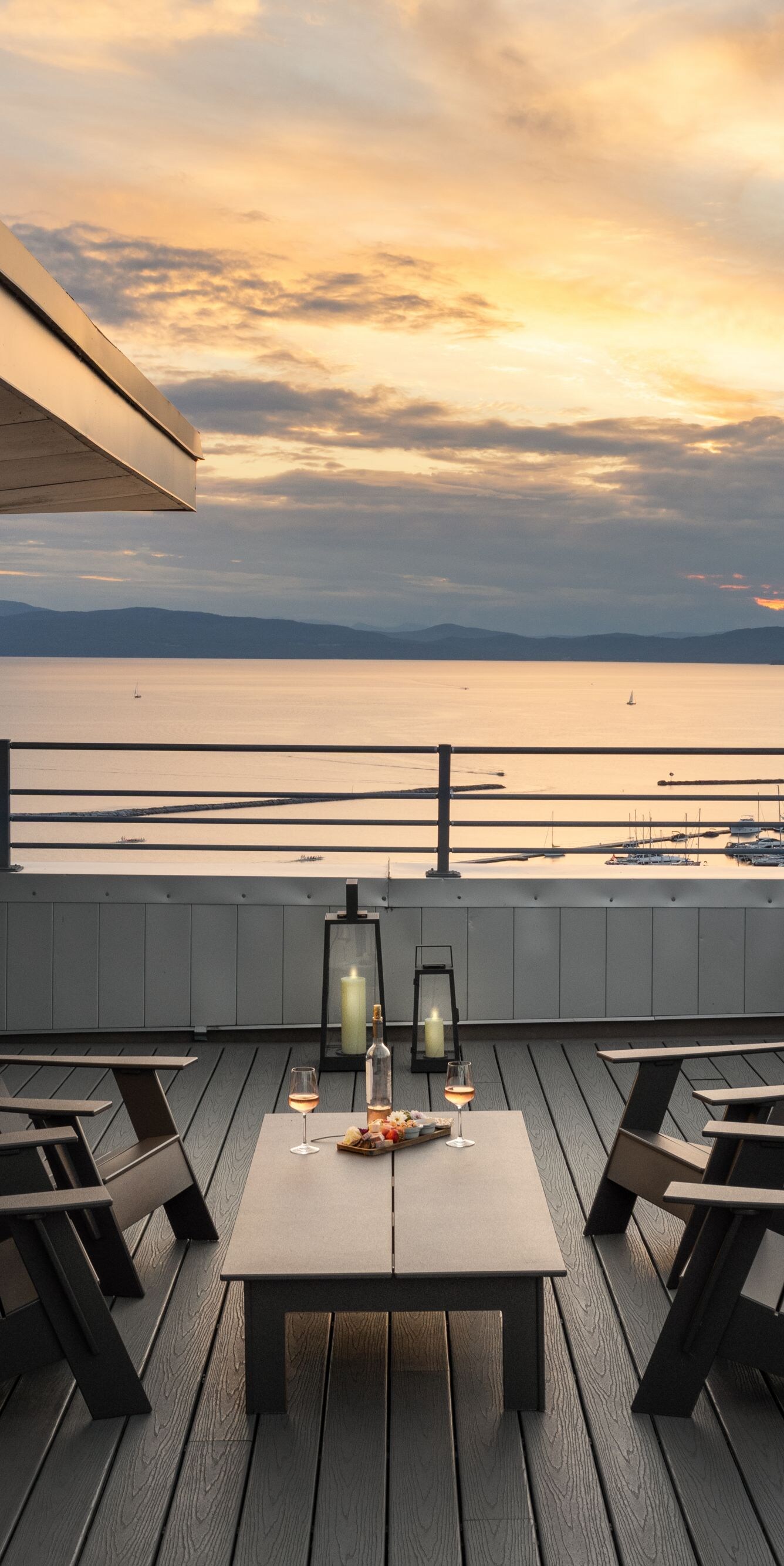 Top floor balcony with chairs and sunset lake view