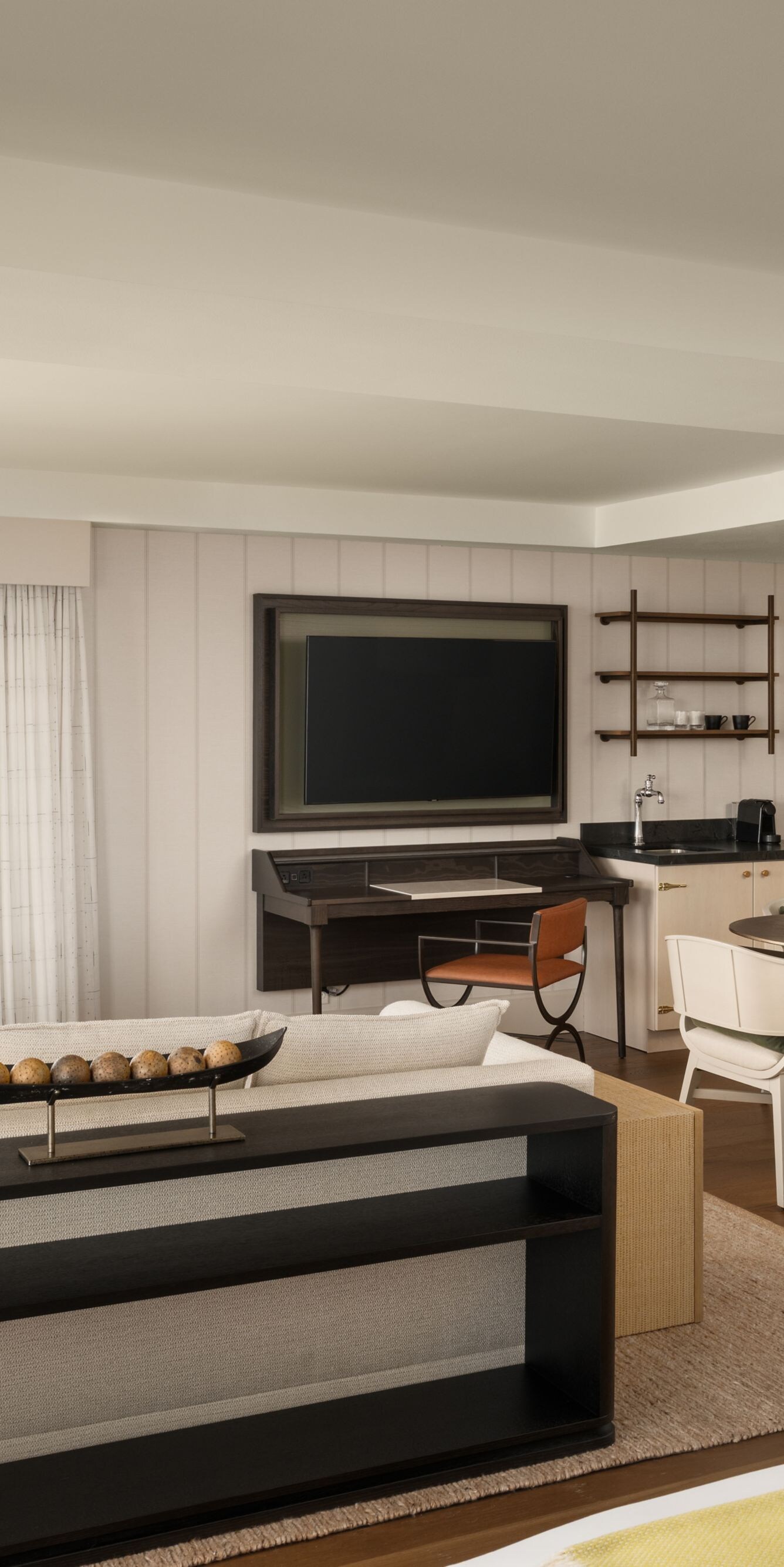 Suite living area with dining table and balcony