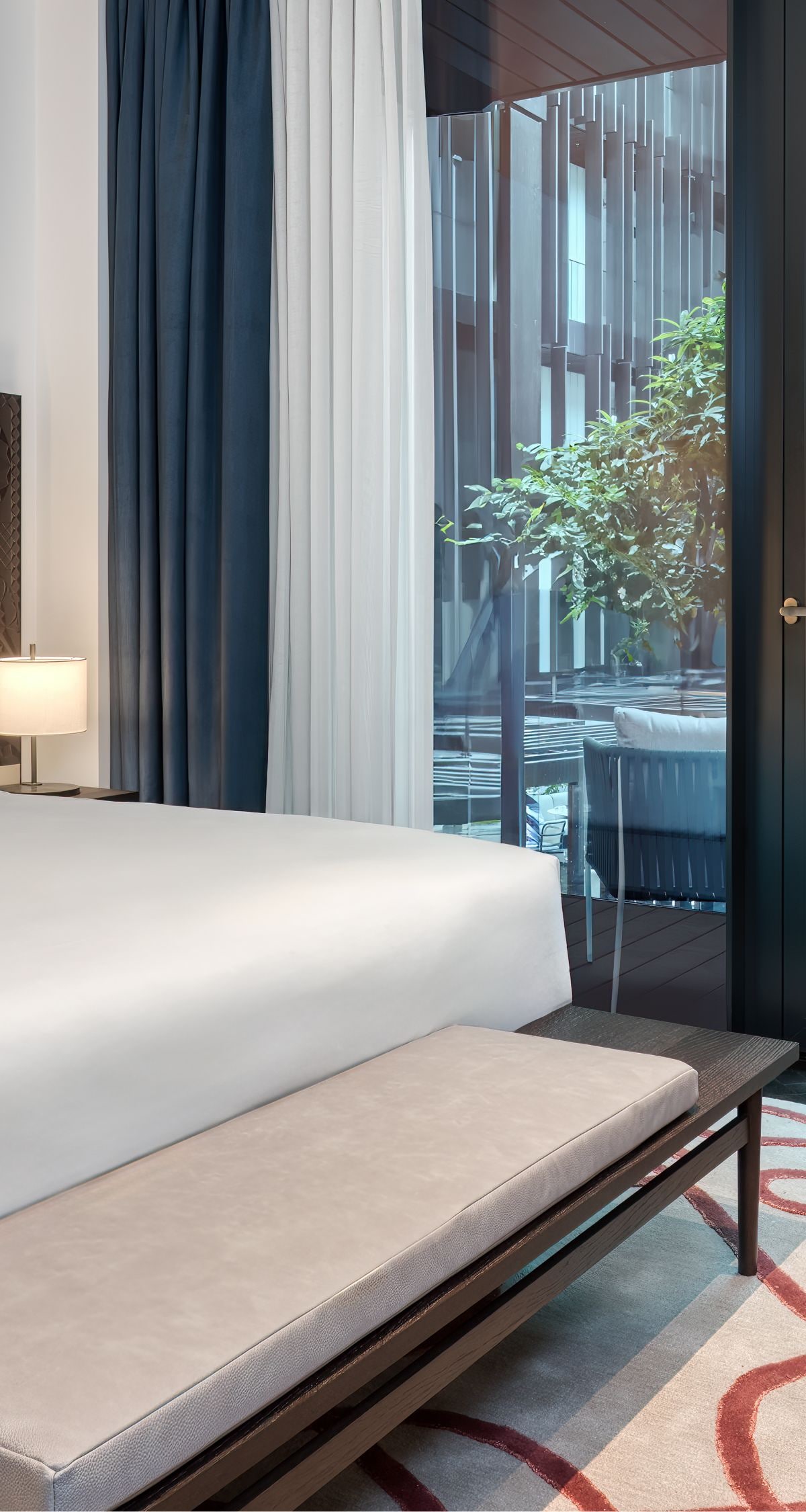 A king bed with a chair placed in the corner 