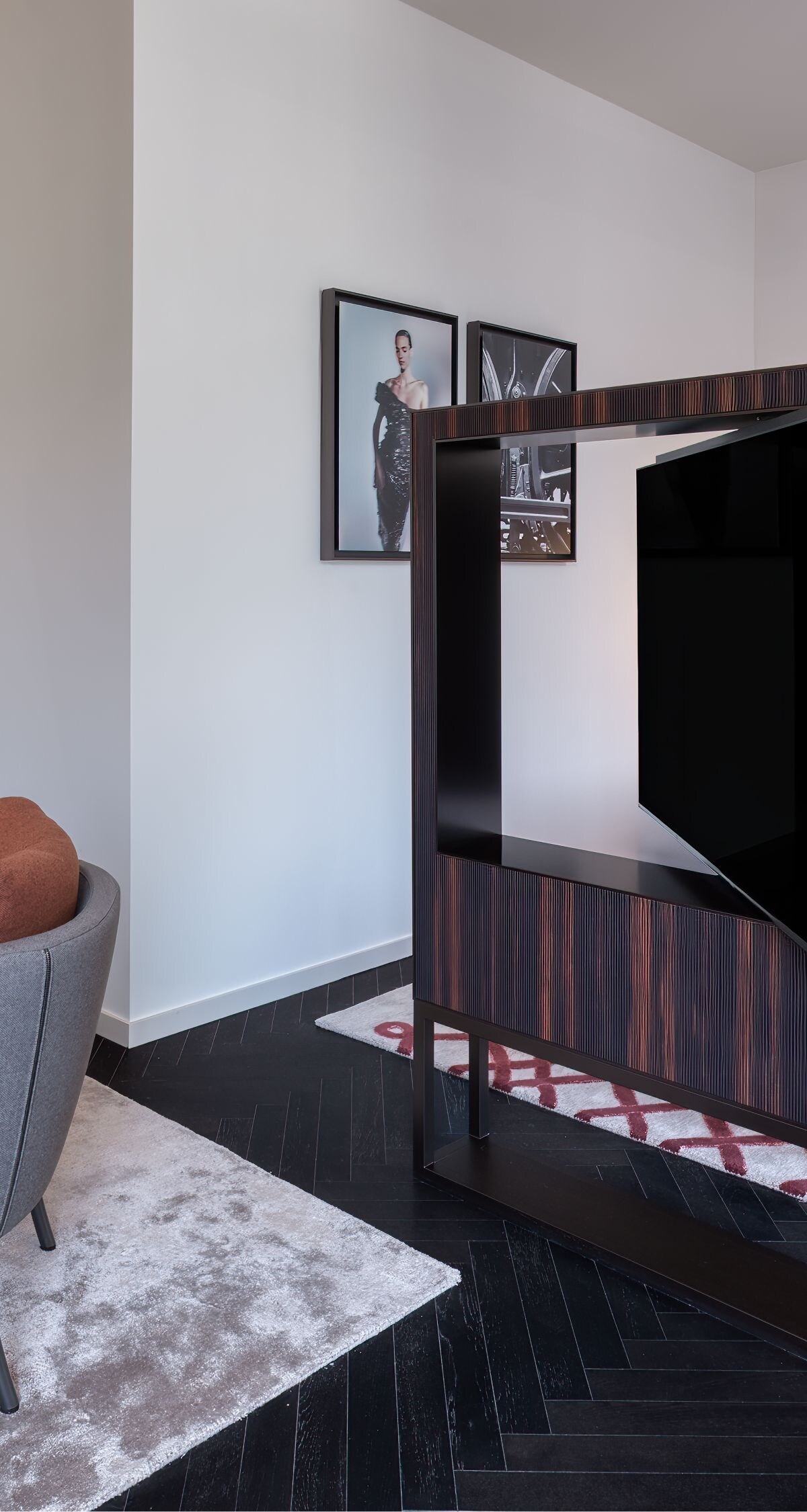 a bed, seating area and TV stand