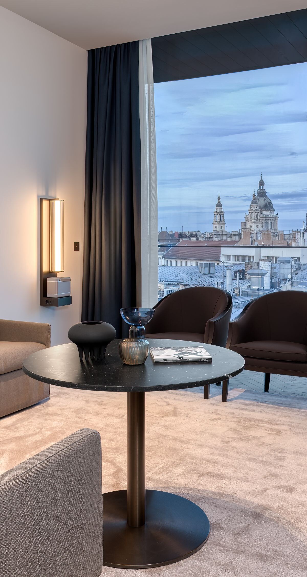 A couch and four chairs placed around a table