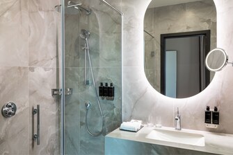 A marble bathroom with a shower.
