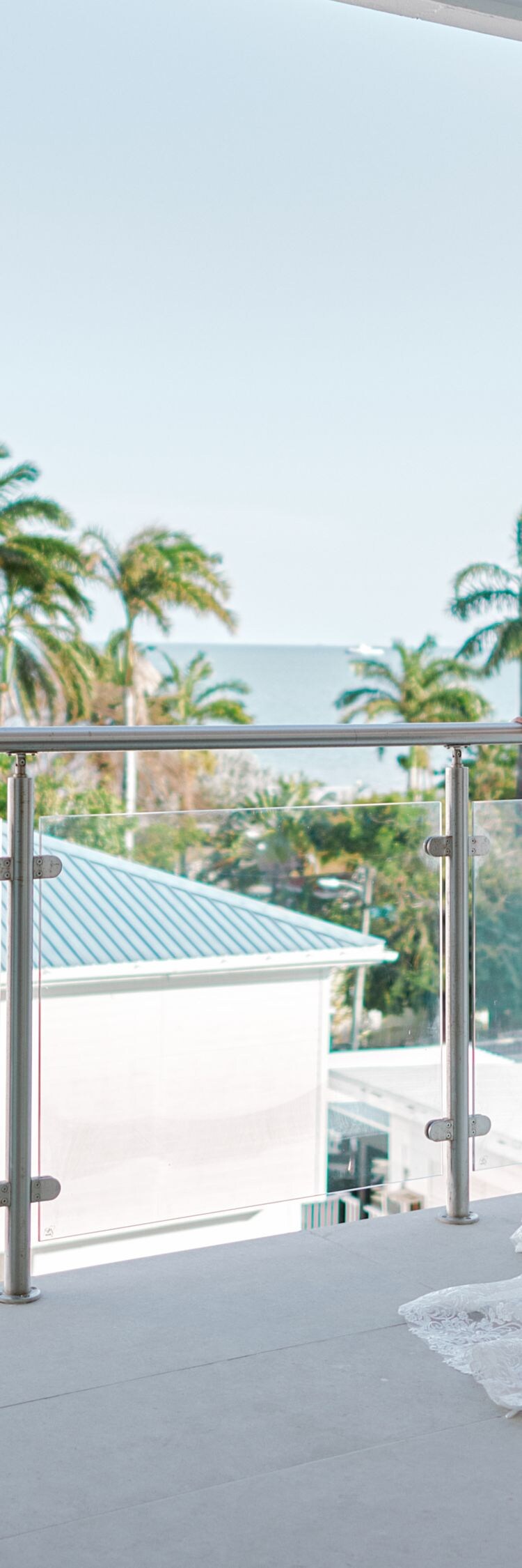 Two persons on balcony with ocean view