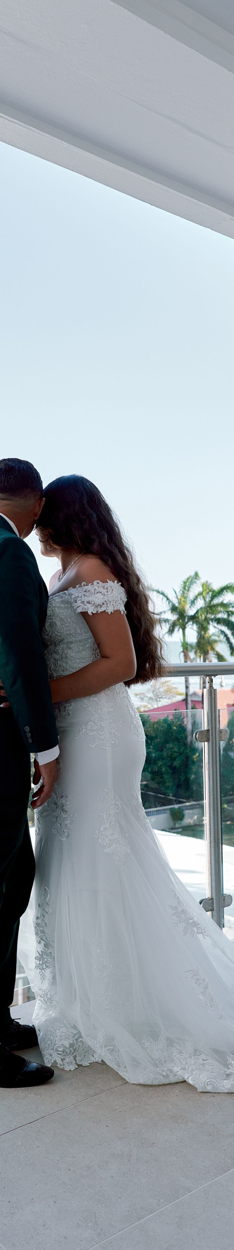 Couple on balcony with palm trees