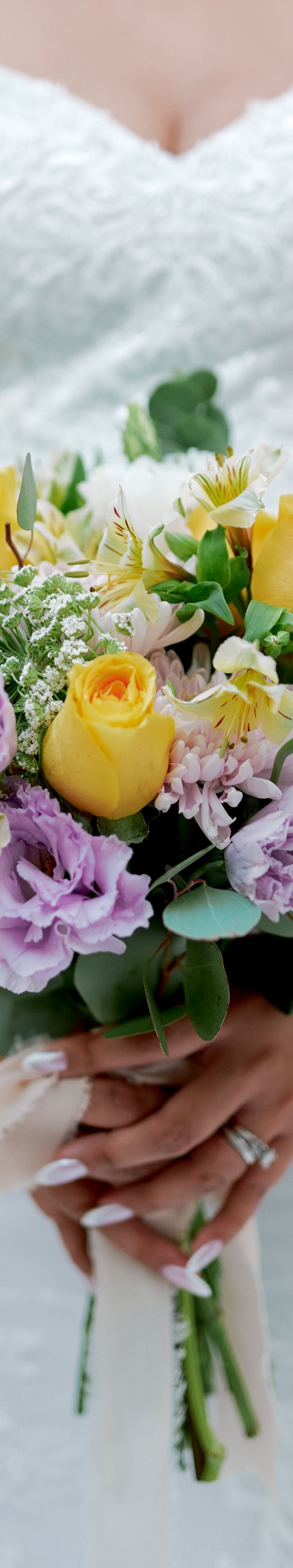 Pastel bouquet held with gown