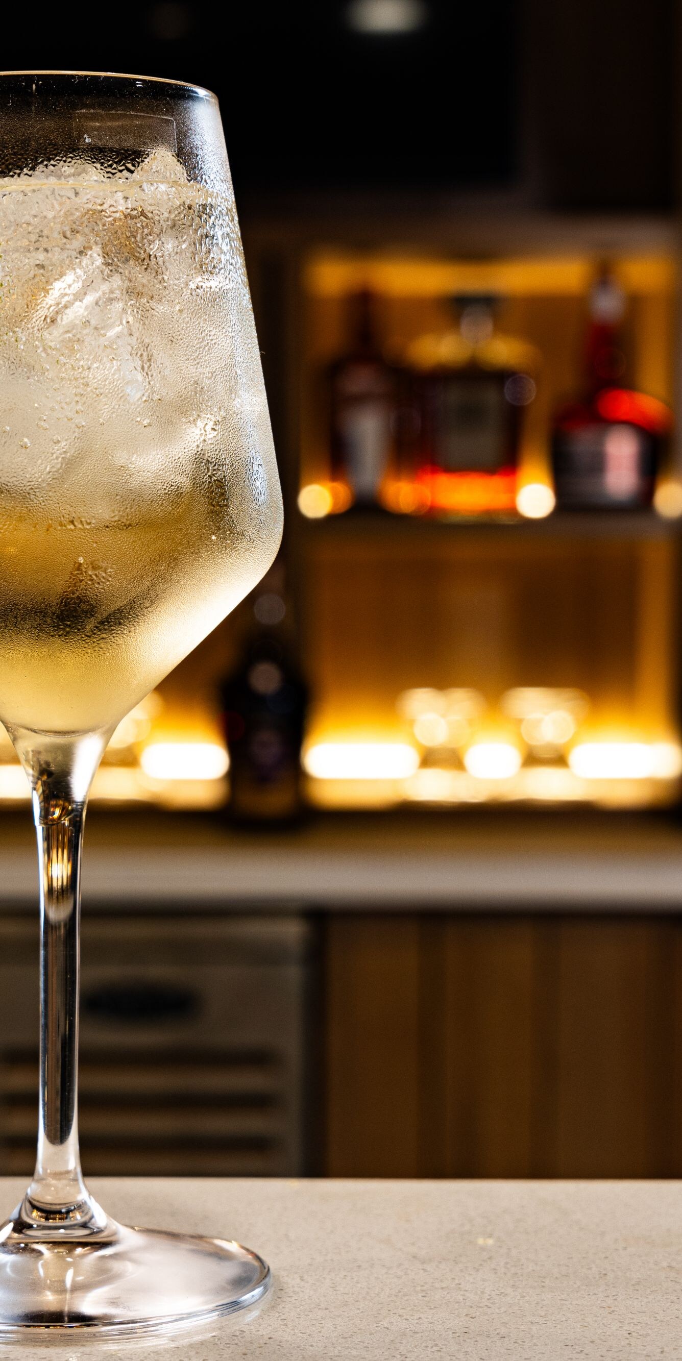 Clear spritz cocktail with lime slice