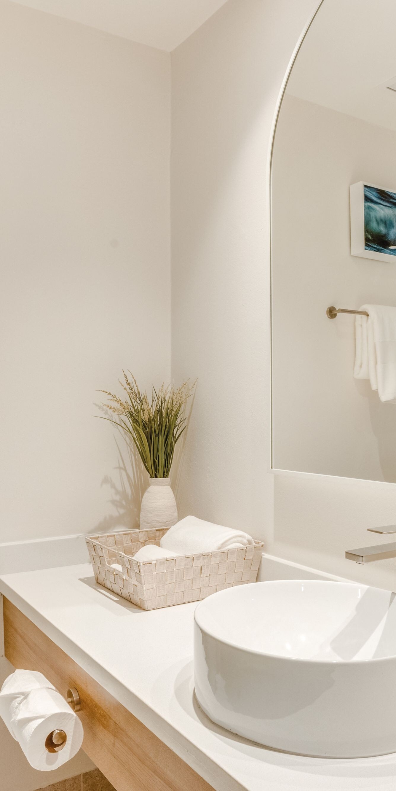 Bathroom vanity with round sink and mirror