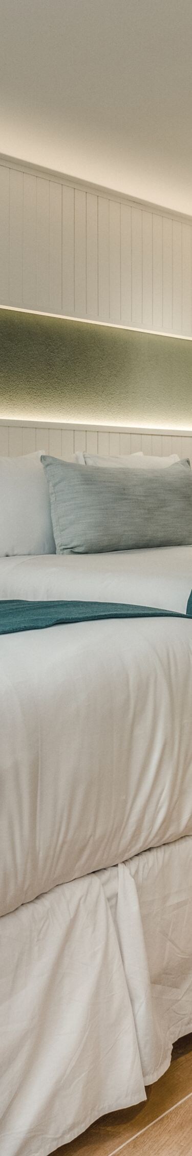Two queen beds with teal accents