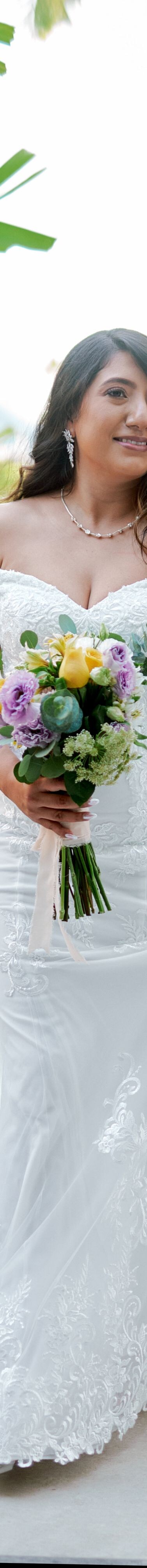 Person holding bouquet in garden path