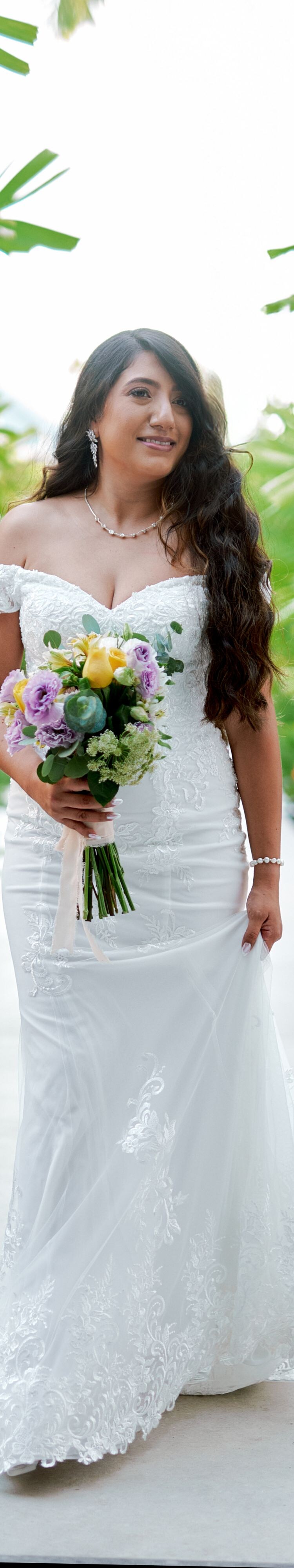 Person holding bouquet in garden path
