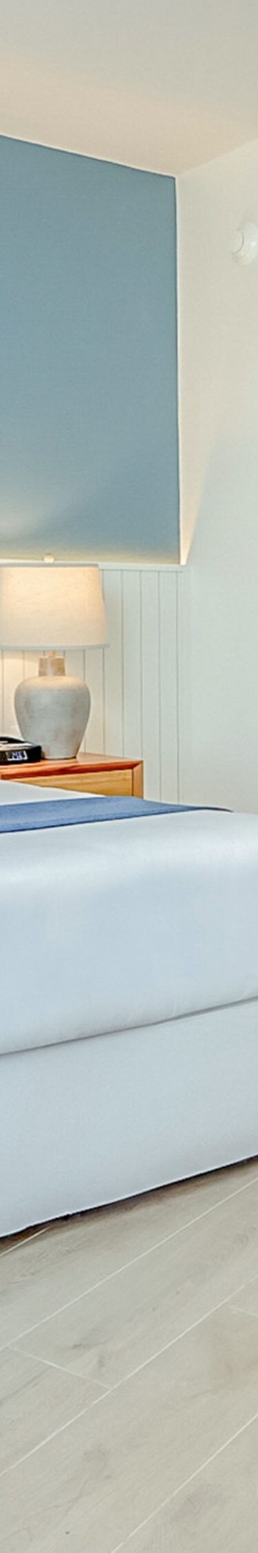 King bed with blue accent wall room