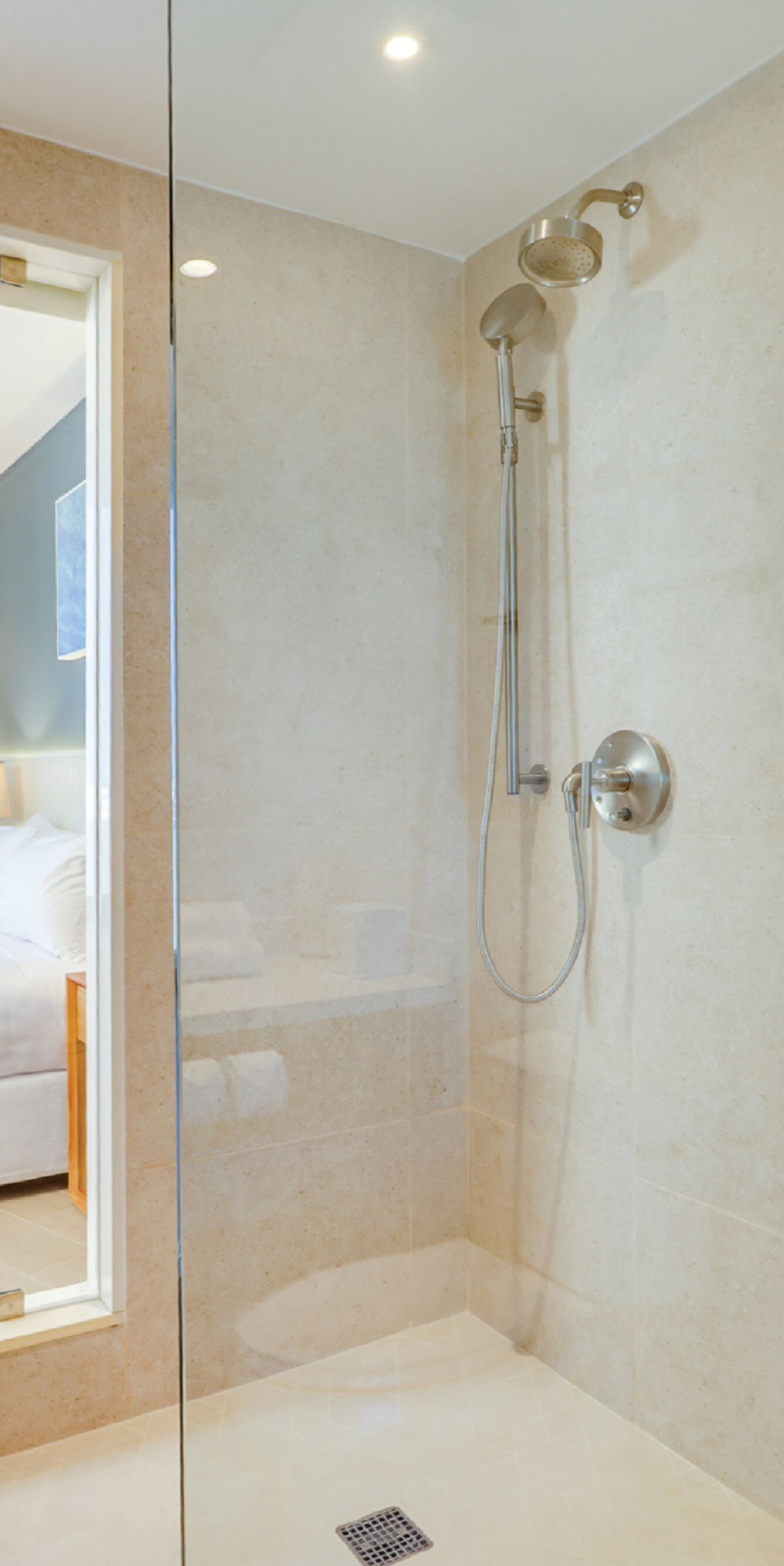Glass shower with beige tile