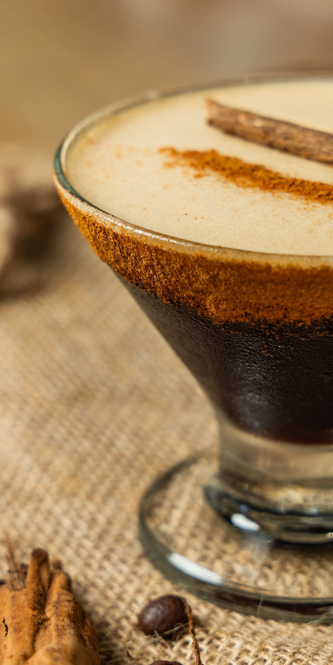 Dark cocktail with cinnamon garnish