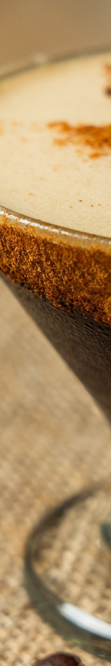 Dark cocktail with cinnamon garnish