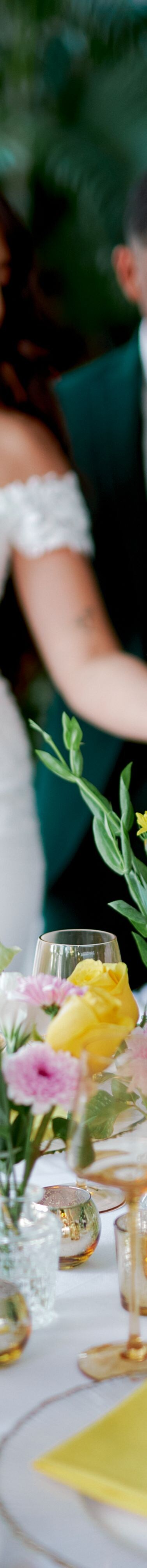 Hands arranging flowers on table