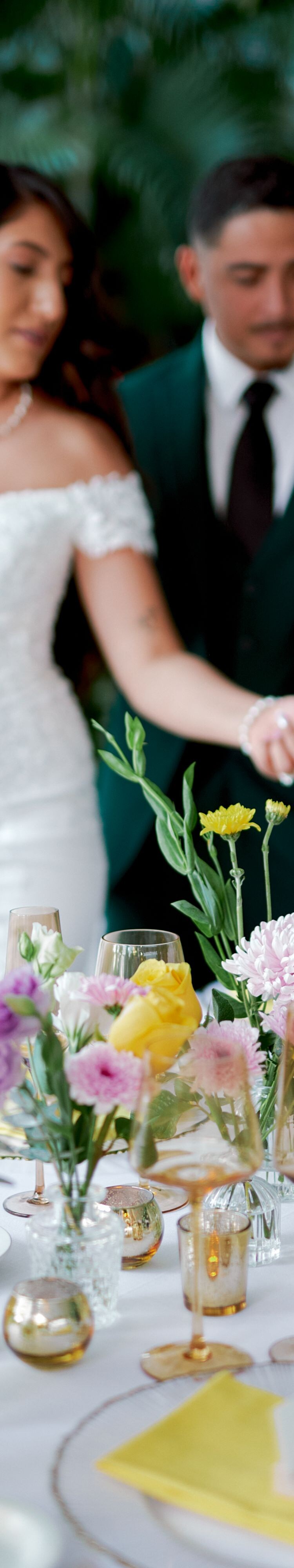 Hands arranging flowers on table