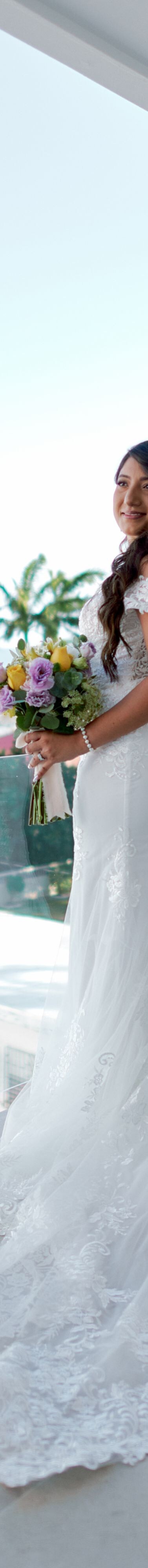 Person holding bouquet on balcony