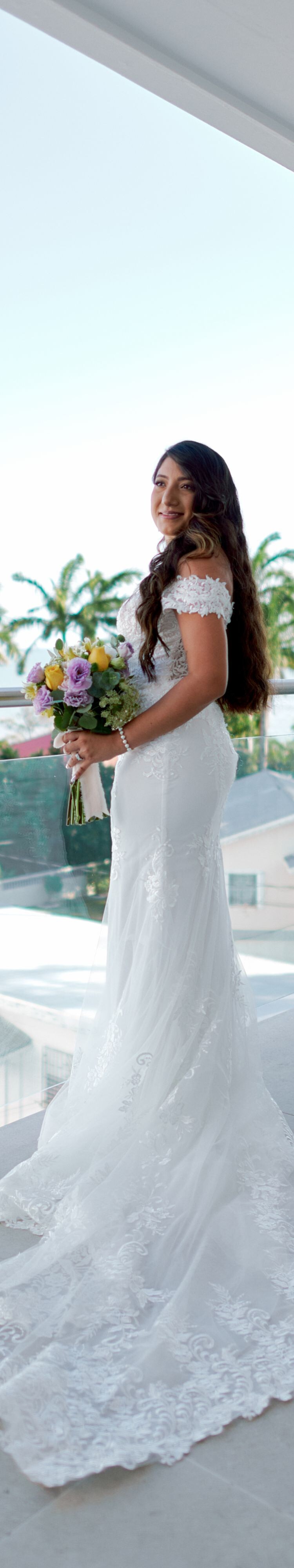 Person holding bouquet on balcony