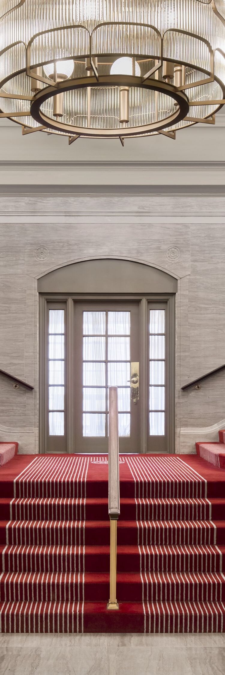 Winding stairwell with red carpet