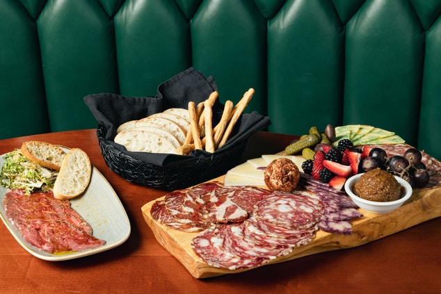 Meat, cheese, and fruit platter with bread
