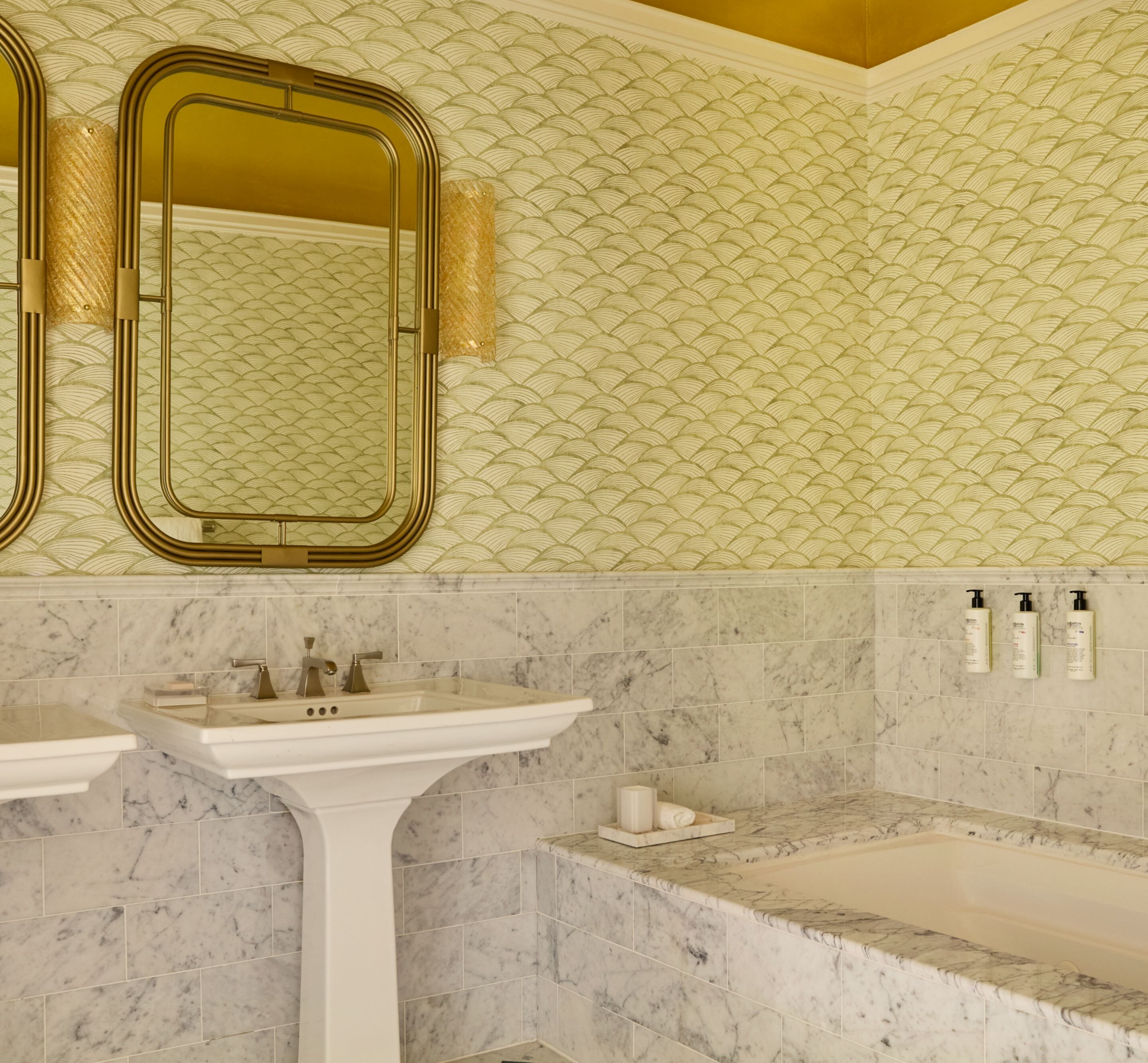Marble bathroom with soaking tub and mirrors