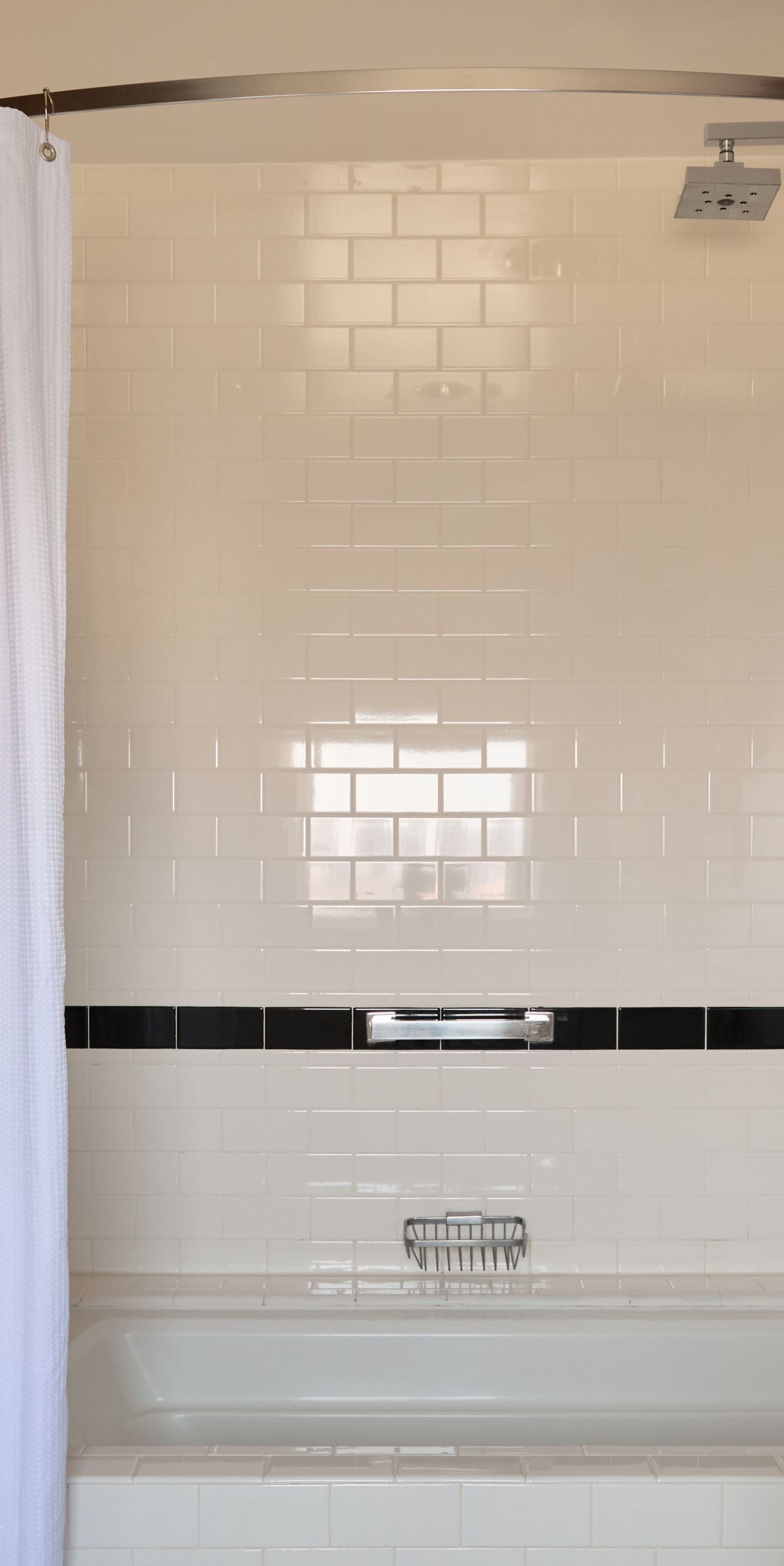 Bathtub and rainfall shower with tiled surround