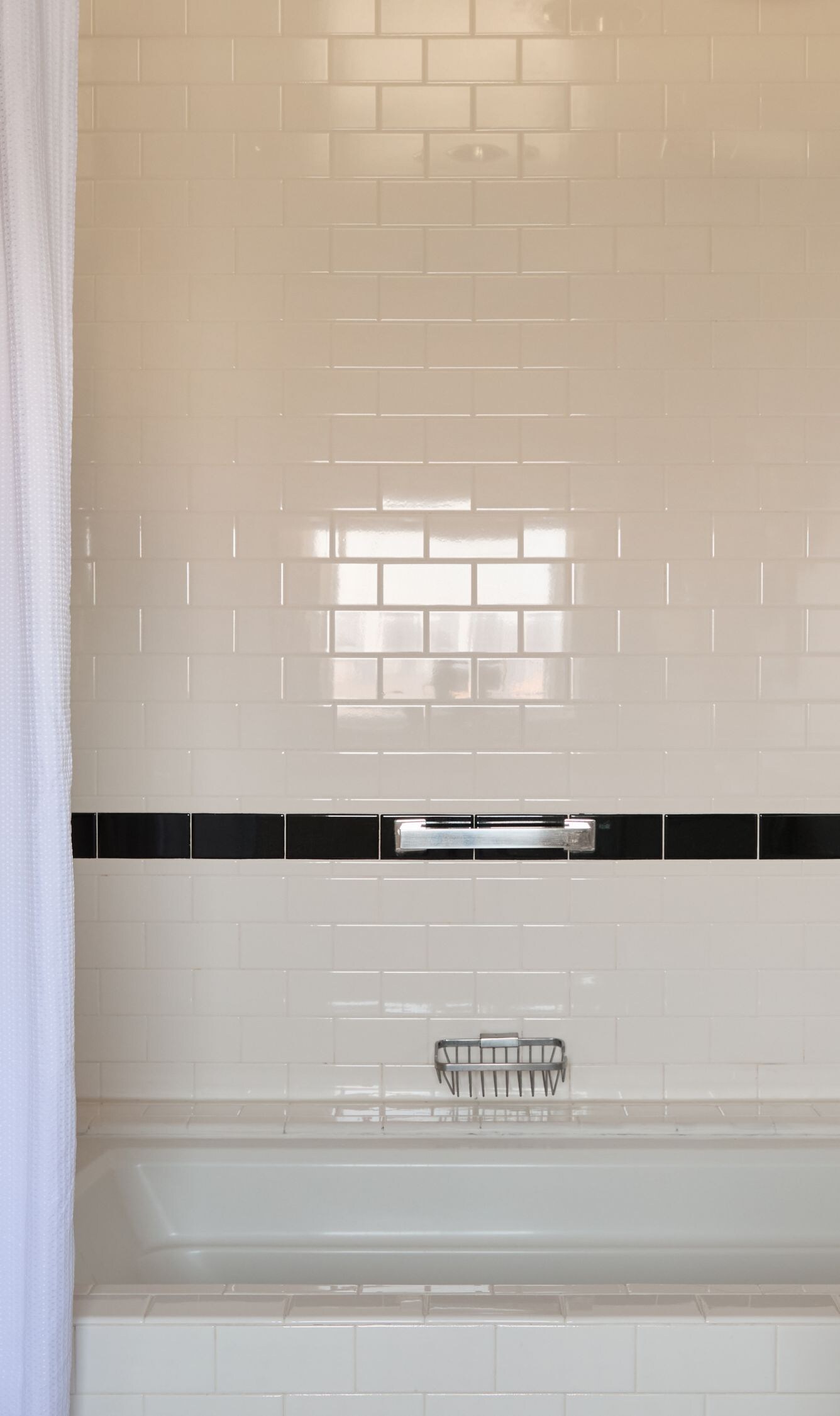 Bathtub and rainfall shower with tiled surround