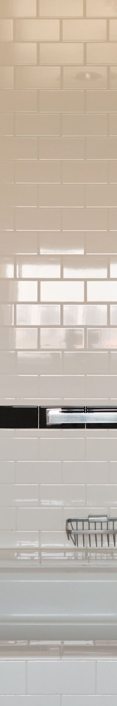 Bathtub and rainfall shower with tiled surround
