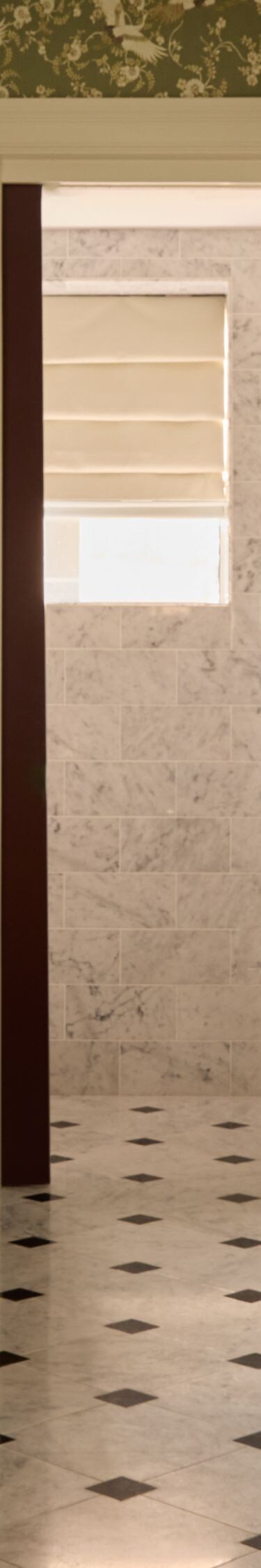 Marble bathroom with dual sinks and glass shower