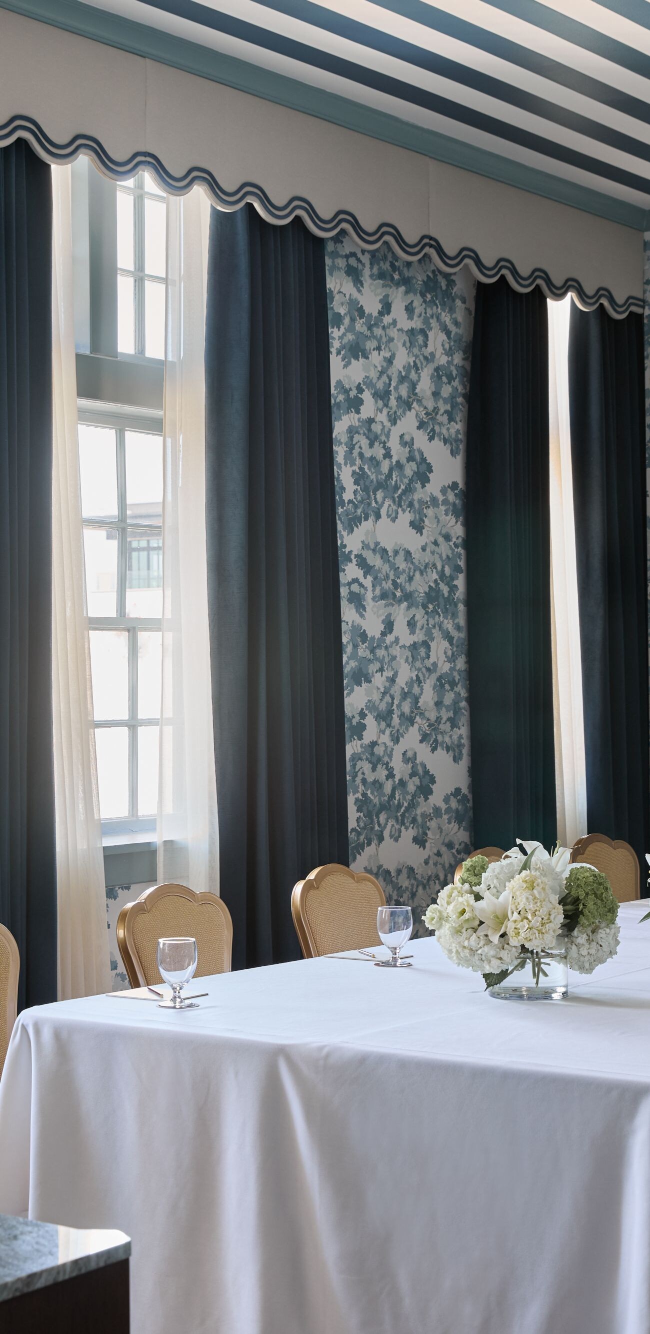 Boardroom with floral centerpieces & tall windows