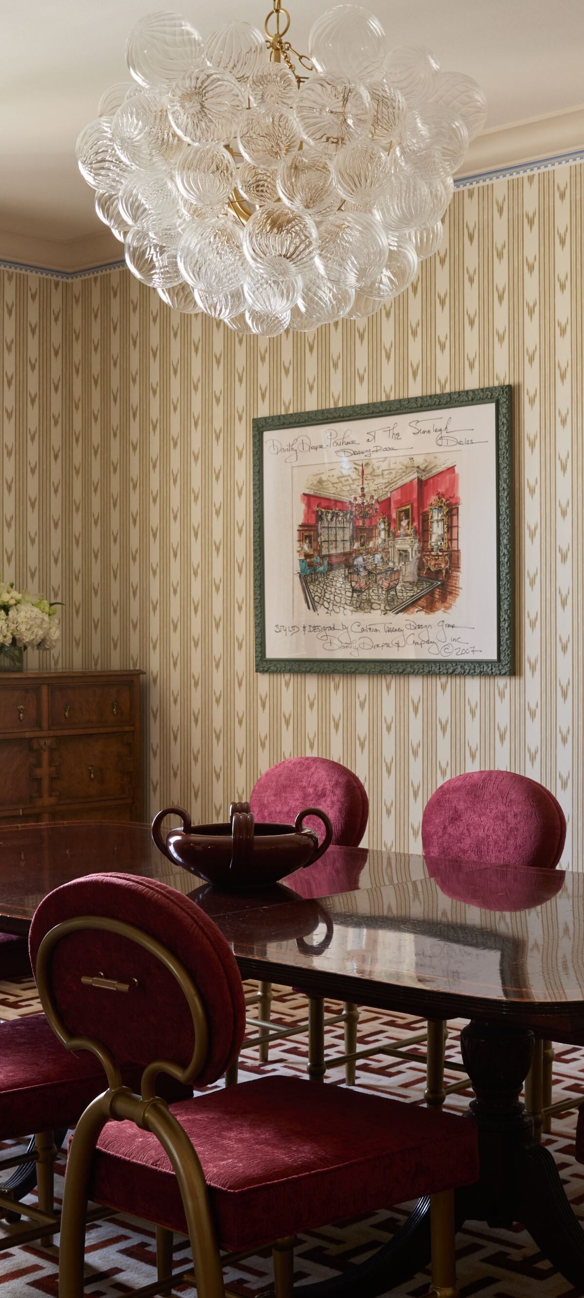Dining room with red velvet chairs and chandelier