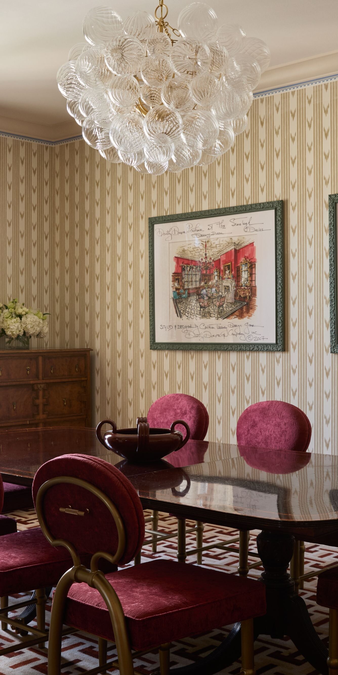 Dining room with red velvet chairs and chandelier