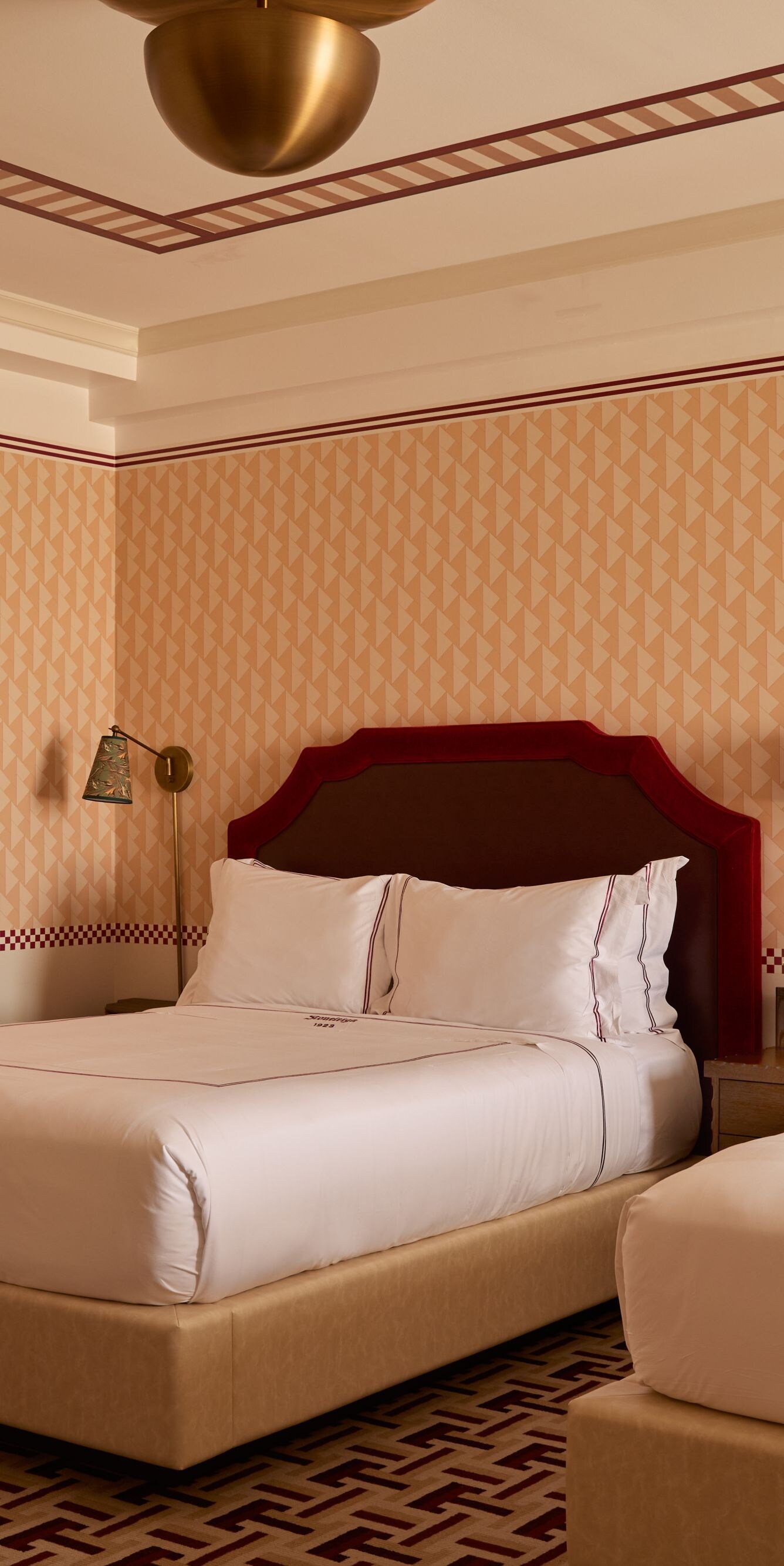 Guest room with two queen beds & patterned décor