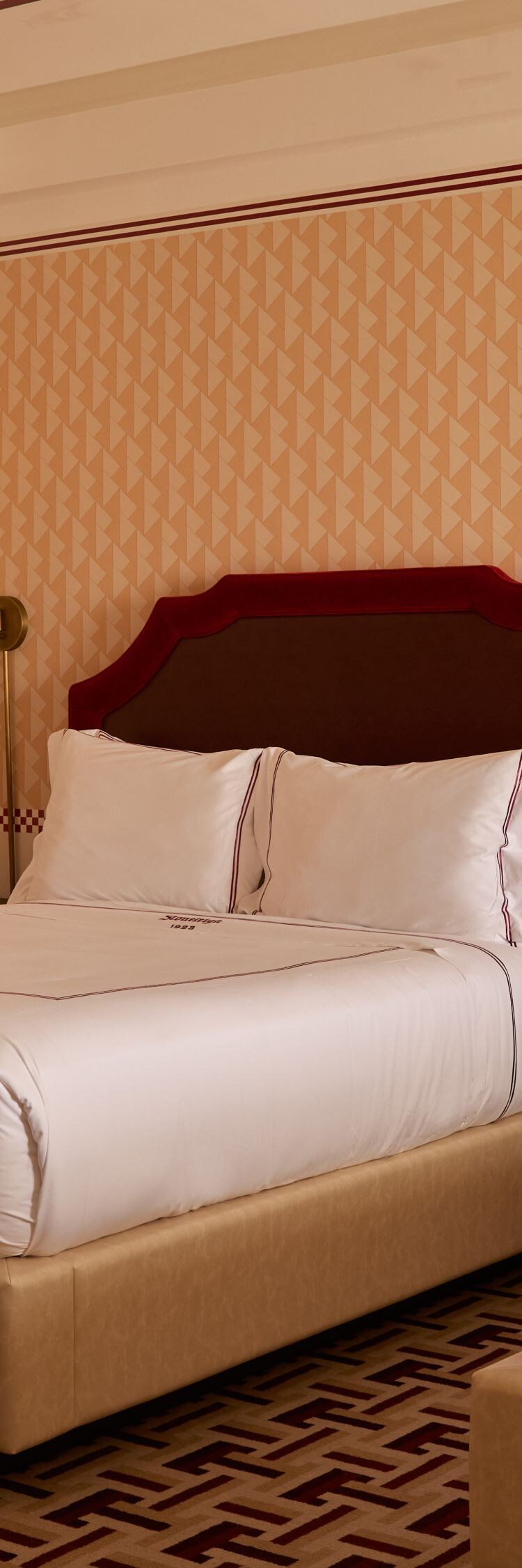 Guest room with two queen beds & patterned décor
