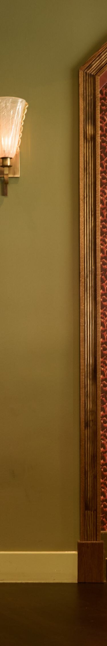 Host stand with floral artwork & arched entryway