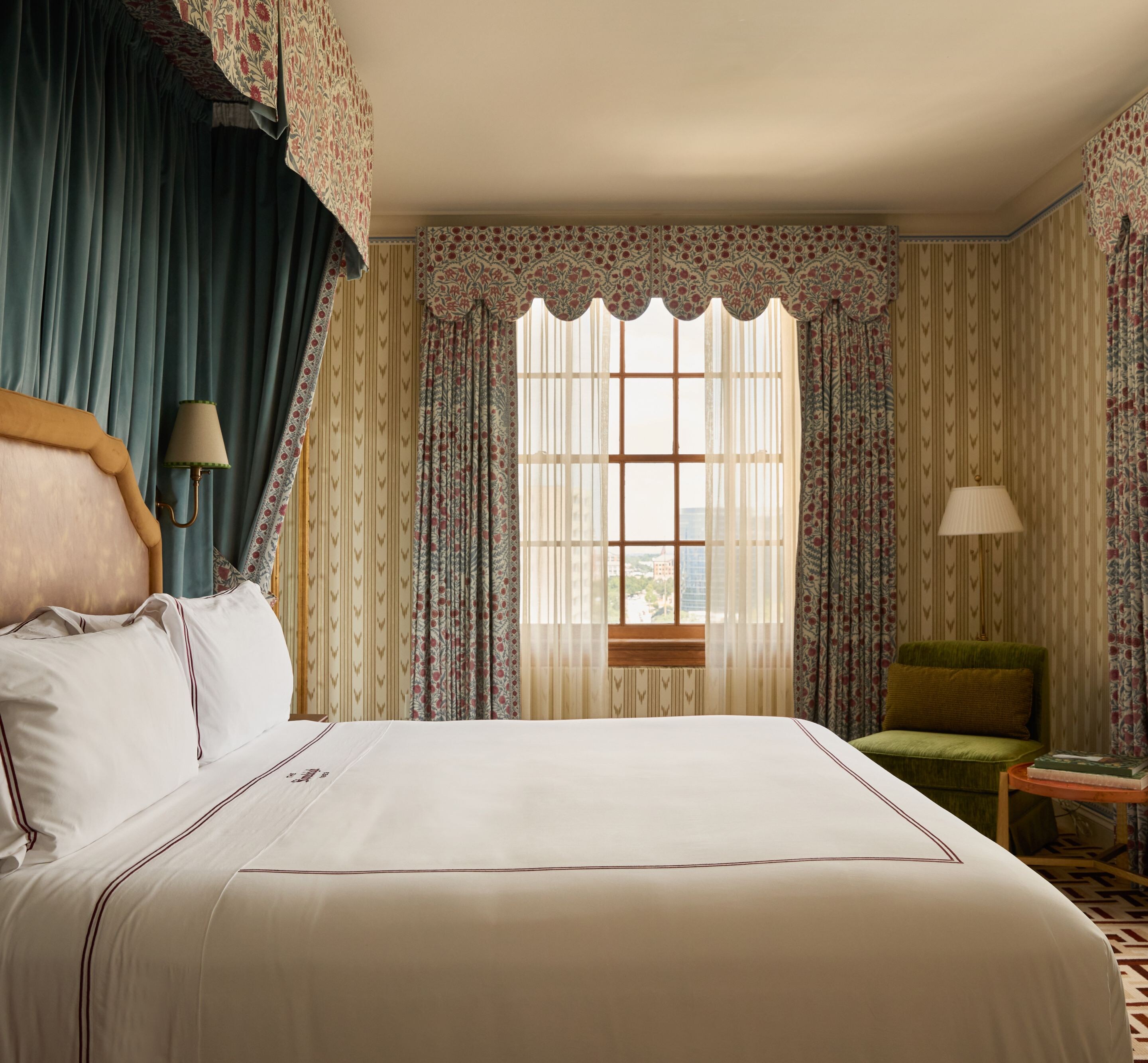 Elegant suite bedroom with canopy bed and view