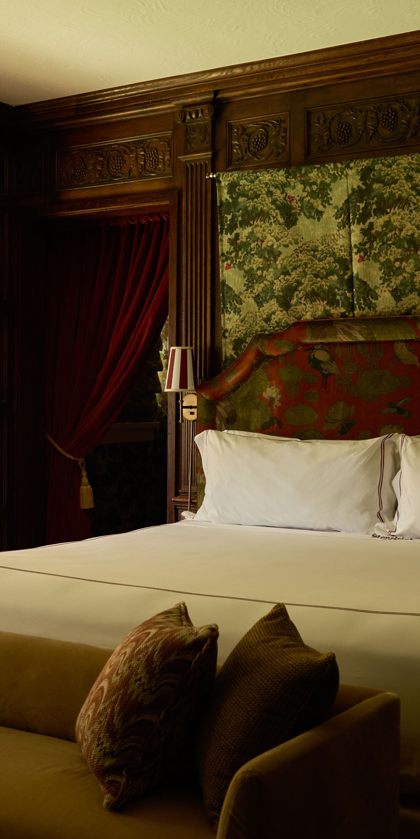 Luxurious suite with king bed and wood paneling