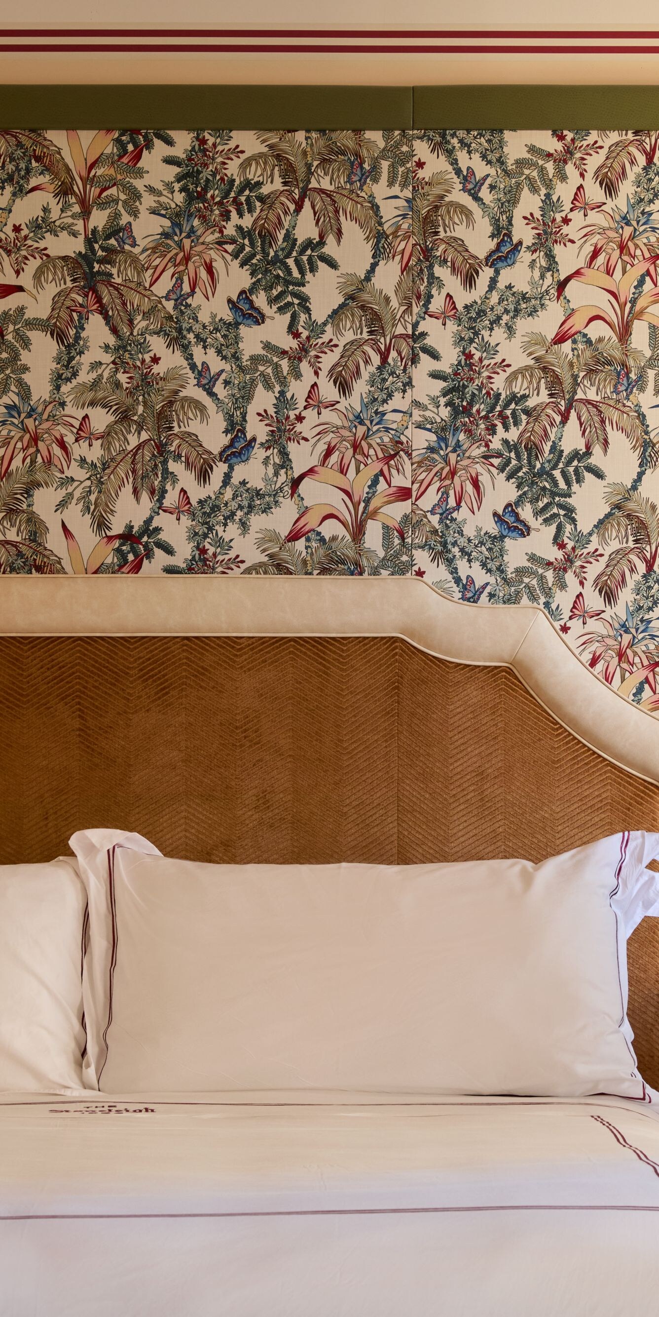 King bed with floral wallcovering 