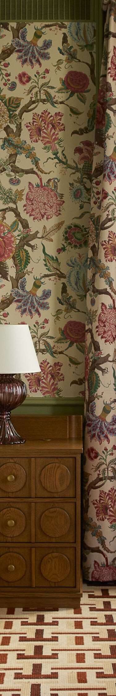 Bedroom with floral canopy bed and seating area