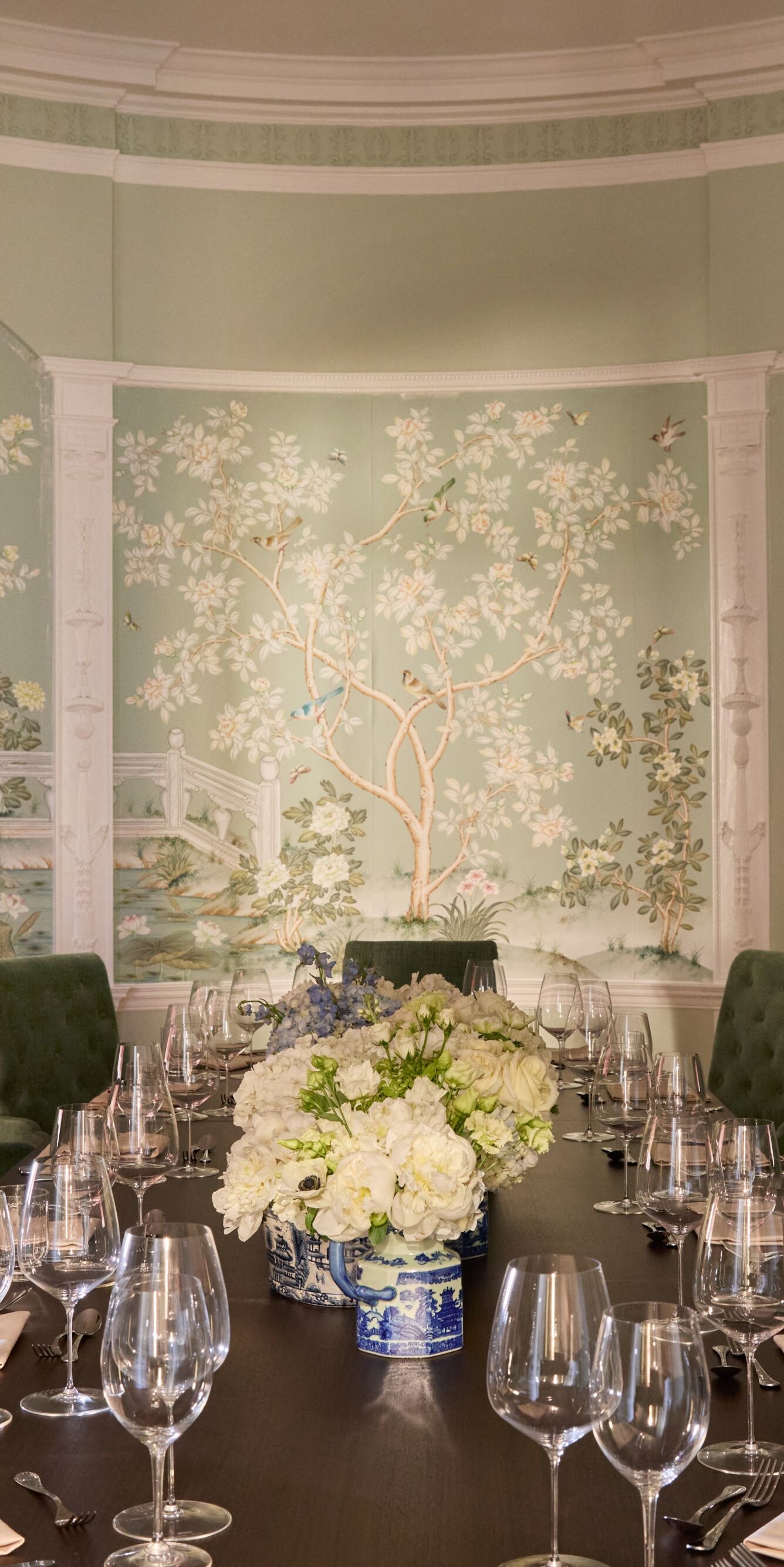 Elegant dining room with mural and flowers