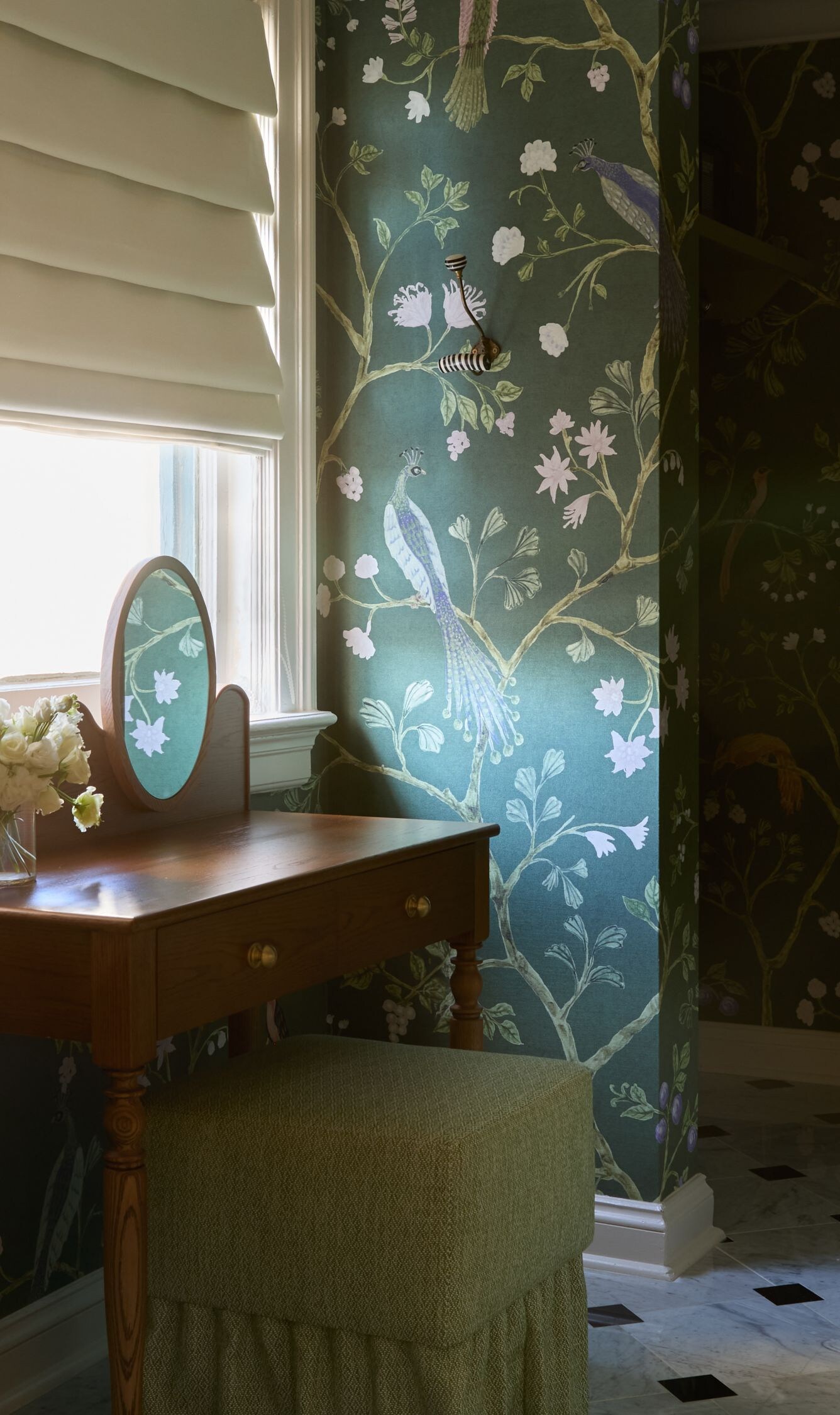 Vanity table with floral wallpaper and mirror