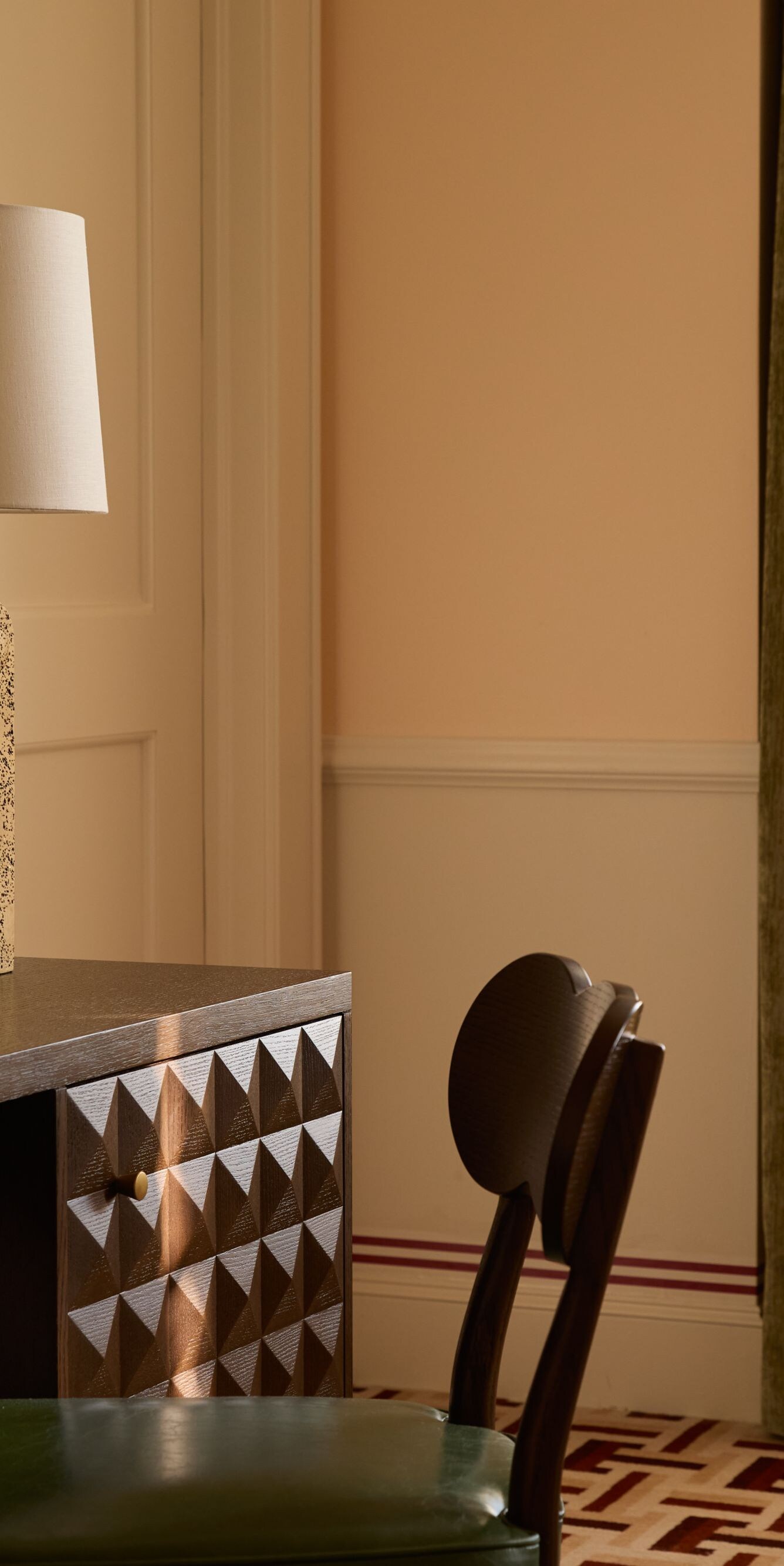 Desk and chair beside window in guest room
